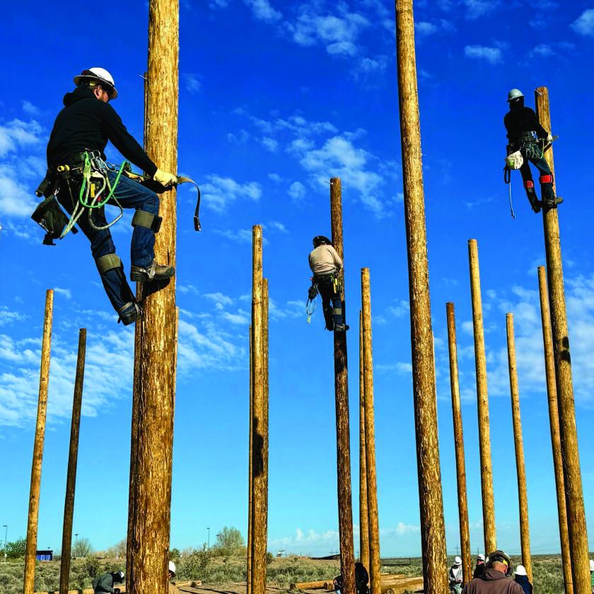 Linemen climbing poles