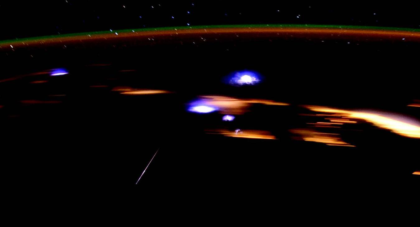 A crew member aboard the International Space Station photographed a Lyrid meteor streaking through the center left, in 2012. The space station was over the Gulf of Mexico, and many coastal cities in several states can be seen as blurry lights in the background. 