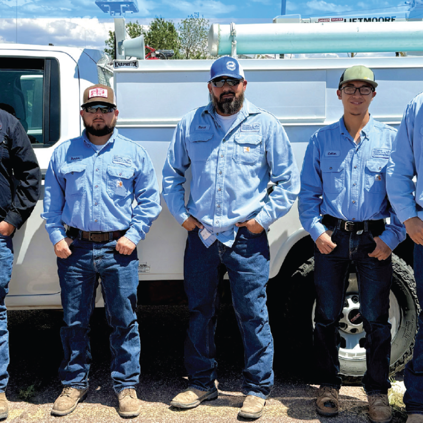Navajo Tribal Utility Authority and Columbus Electric Cooperative crew members work together to bring electricity to remote homes in Navajo Nation as part of the Light Up Navajo initiative. From left: Leander Begay, NTUARM journeyman lineworker; Leo Kayanni, NTUASR foreman; Porter Howard, CEC journeyman lineworker; Daniel Lopez, CEC line superintendent; Colton Villegas, CEC apprentice lineworker; Frankie Gonzales, CEC apprentice lineworker; and Leander Black, NTUAKY journeyman lineworker.