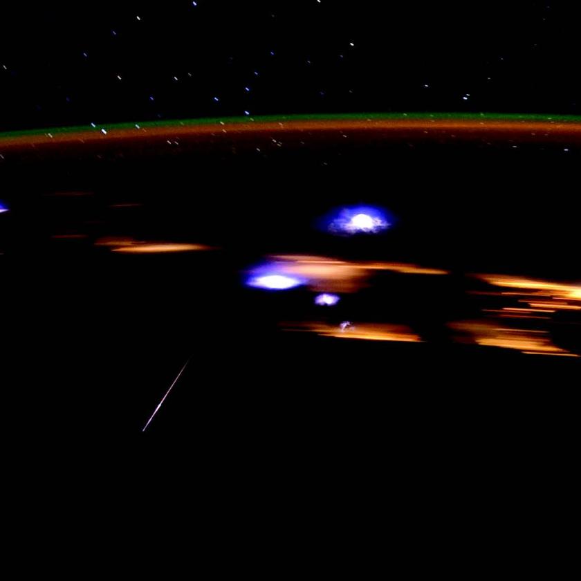 A crew member aboard the International Space Station photographed a Lyrid meteor streaking through the center left, in 2012. The space station was over the Gulf of Mexico, and many coastal cities in several states can be seen as blurry lights in the background. 